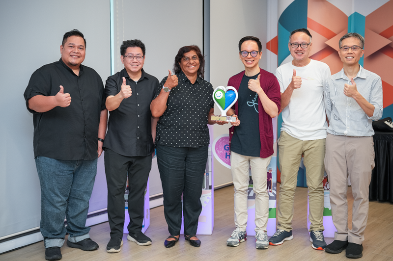 Group photo of staff from Singapore Polytechnic with the award trophy at the Caring Commuter Week 2025